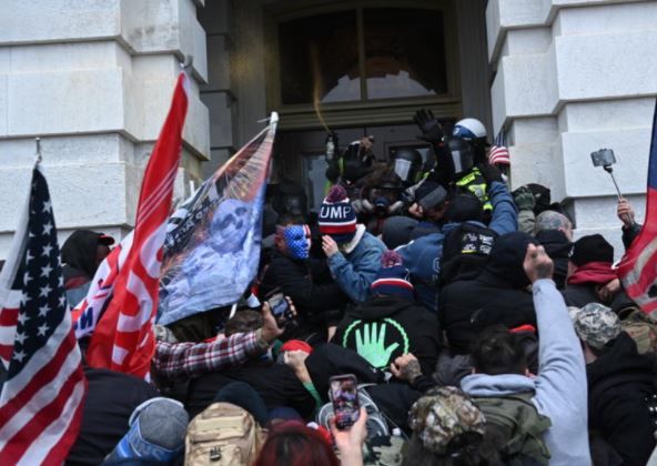 Trump supporters clash with police as they storm the US Capitol on 6 January 2021. Brendan Smialowski/ AFP