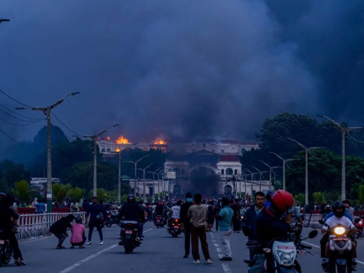 Demonstrators set fire to the Parliament building in Kathmandu. (Photo by Ambir Tolang / NurPhoto via AFP)