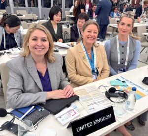 Rt Hon Dame Karen Bradley DBE MP, Helen Maguire MP and Rosie Wrighting MP at UK desk in the conference plenary