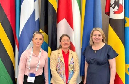 Rt Hon Dame Karen Bradley DBE MP, Helen Maguire MP and Rosie Wrighting MP stand at UK Flag