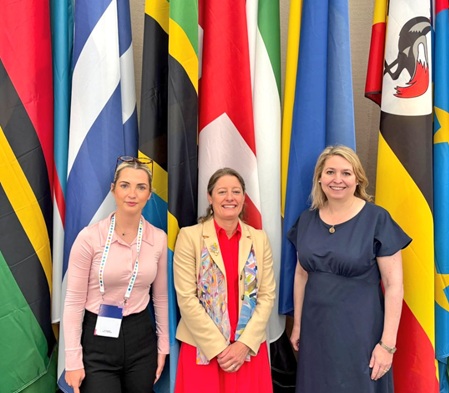 Rt Hon Dame Karen Bradley DBE MP, Helen Maguire MP and Rosie Wrighting MP stand at UK Flag
