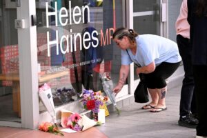 A woman places flowers outside the office of Australian politician Helen Haines in Wangaratta. ©William West / AFP